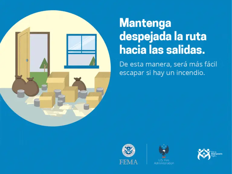 Illustration displaying boxes and bags cluttering an area near a door and window. The text in Spanish advises to keep exit routes clear for easier evacuation in case of a fire. Logos of FEMA, U.S. Fire Administration, and a safety campaign appear at the bottom.